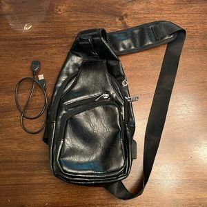 Black pleather side sling bag with USB connector